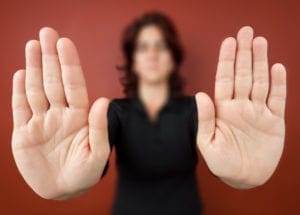 Woman with her two hands extended signaling to stop